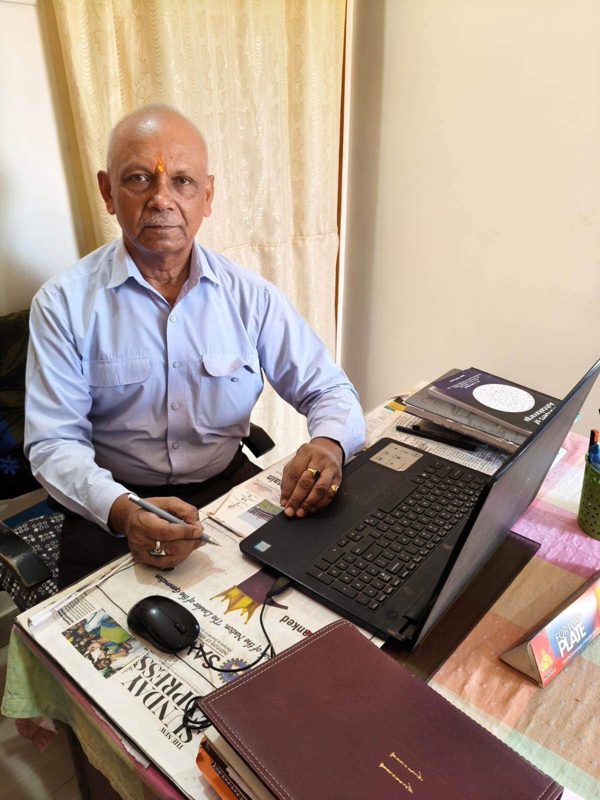Dr. Bipin Bihari Lal at his consultation desk in Varanasi